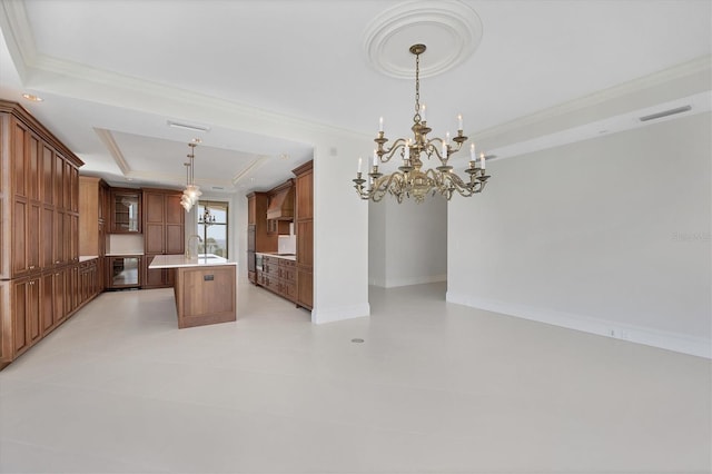 kitchen featuring a tray ceiling, light tile patterned floors, a center island with sink, an inviting chandelier, and hanging light fixtures