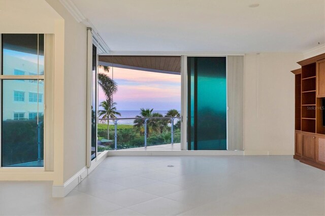 unfurnished room with floor to ceiling windows and ornamental molding