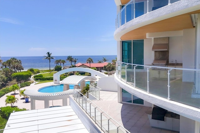 balcony with a grill and a water view