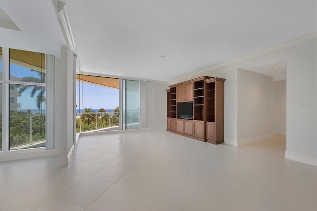 unfurnished living room featuring plenty of natural light, ornamental molding, and a wall of windows