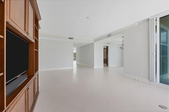 unfurnished living room featuring a chandelier and light tile patterned floors