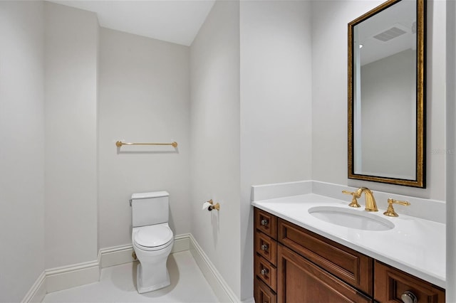 bathroom with tile patterned floors, vanity, and toilet