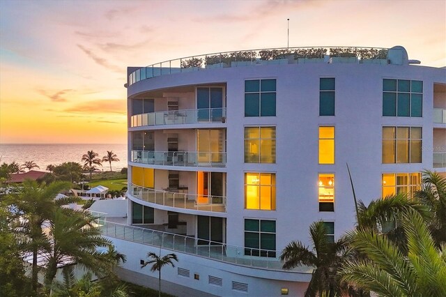 outdoor building at dusk featuring a water view