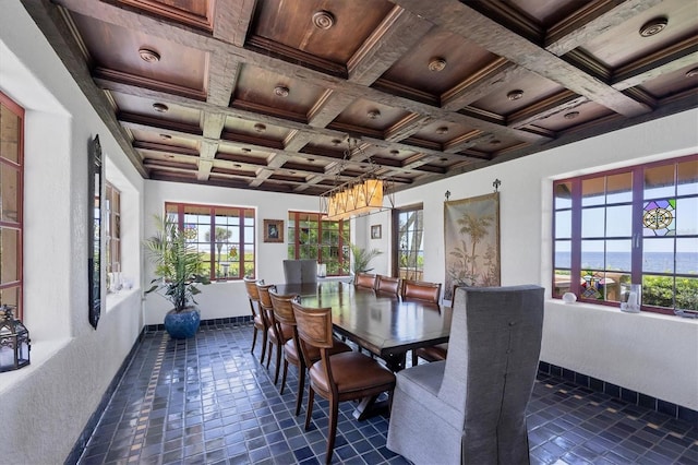 tiled dining space with wooden ceiling, coffered ceiling, beamed ceiling, a water view, and ornamental molding