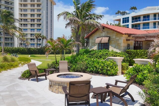 view of home's community with a fire pit and a patio area