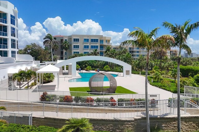 view of property's community with a water view and a swimming pool