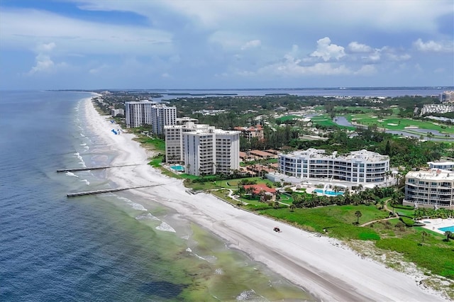 birds eye view of property with a water view and a beach view