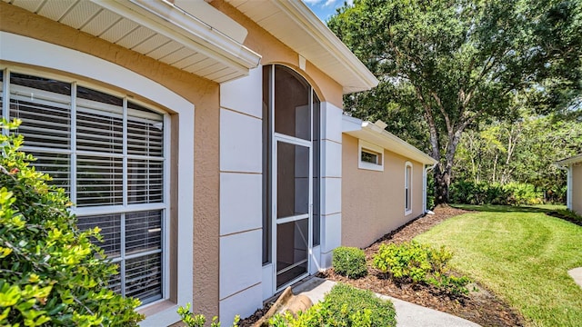 property entrance with a yard