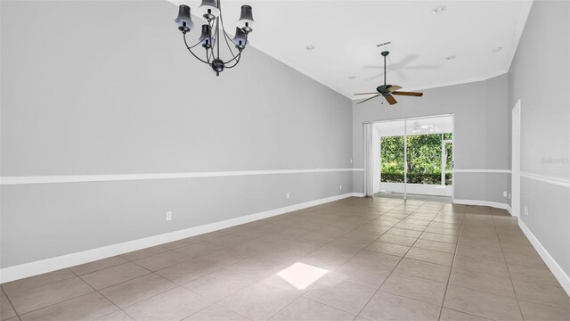 empty room featuring light tile patterned floors, ceiling fan with notable chandelier, and vaulted ceiling