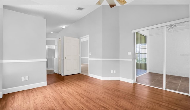 unfurnished bedroom featuring hardwood / wood-style floors, a closet, and ceiling fan