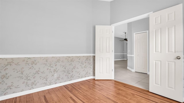 spare room featuring hardwood / wood-style flooring and ceiling fan