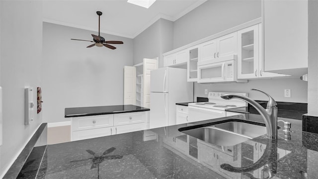 kitchen featuring crown molding, white appliances, dark stone counters, and white cabinets