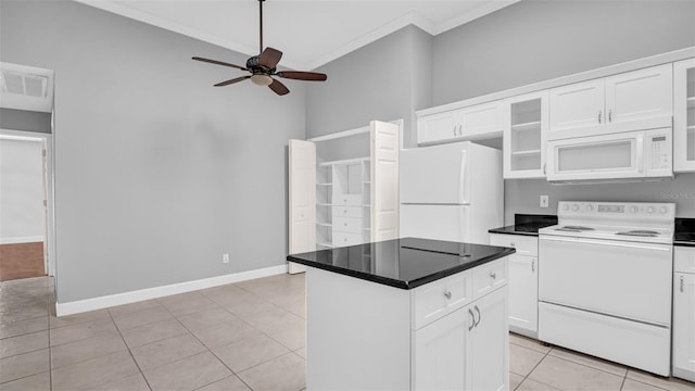 kitchen with light tile patterned floors, white appliances, ceiling fan, a center island, and white cabinets