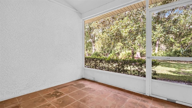 unfurnished sunroom with lofted ceiling