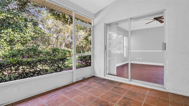 unfurnished sunroom featuring ceiling fan