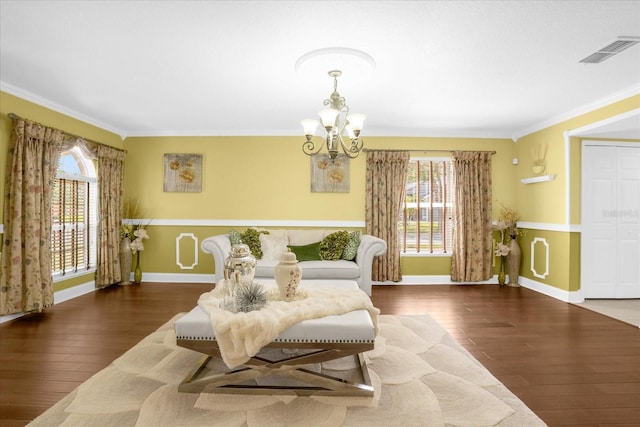 sitting room featuring a notable chandelier, crown molding, and dark hardwood / wood-style floors