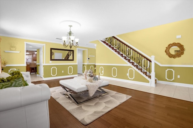 living room featuring an inviting chandelier, hardwood / wood-style floors, and ornamental molding