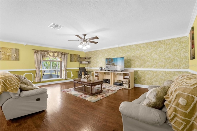 living room with ornamental molding, ceiling fan, a textured ceiling, and dark hardwood / wood-style flooring