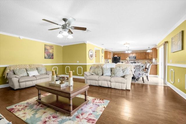 living room featuring crown molding, dark hardwood / wood-style floors, and ceiling fan