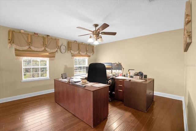 office space with dark wood-type flooring and ceiling fan