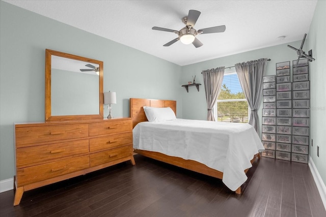 bedroom with dark wood-type flooring and ceiling fan