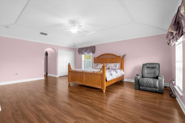 bedroom with lofted ceiling, ornamental molding, dark hardwood / wood-style floors, and ceiling fan