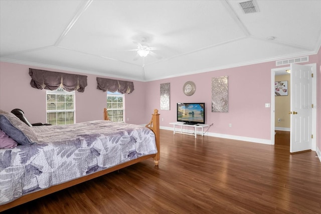 bedroom featuring ceiling fan, ornamental molding, dark hardwood / wood-style flooring, and a raised ceiling