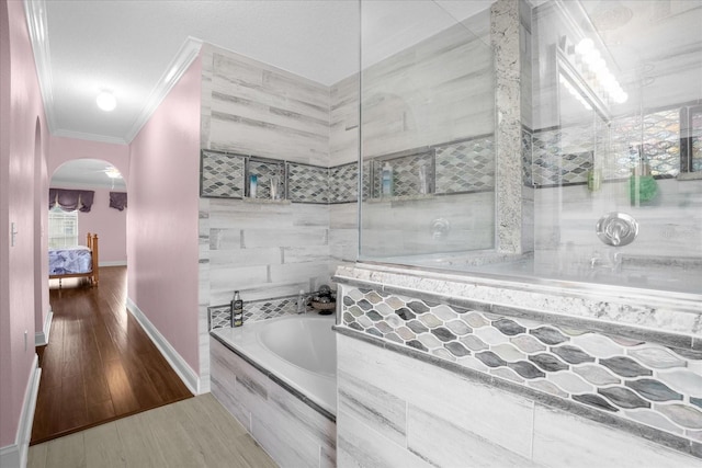 bathroom with ornamental molding, shower with separate bathtub, and hardwood / wood-style floors