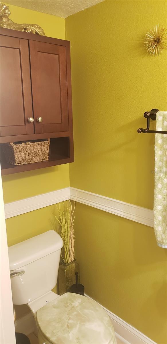 bathroom with a textured ceiling and toilet