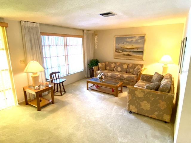 carpeted living room featuring a textured ceiling