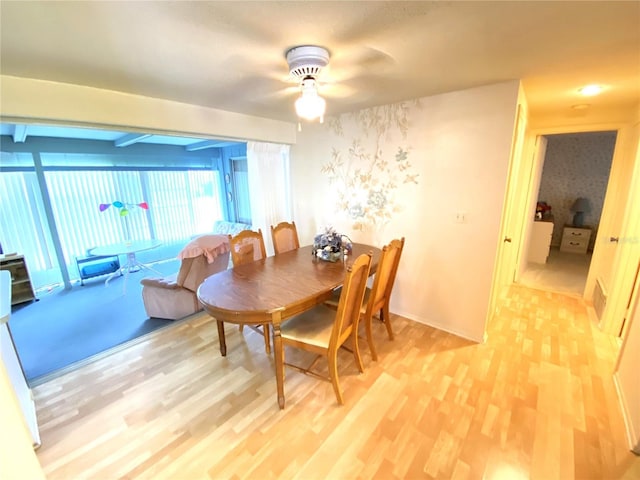 dining room with ceiling fan and light wood-type flooring