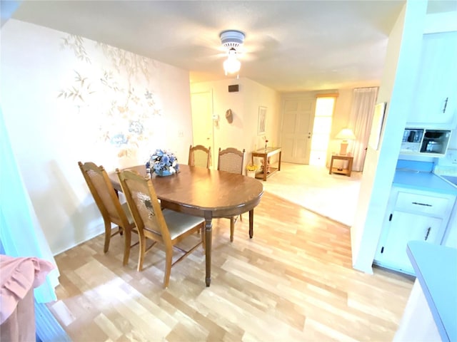 dining room featuring ceiling fan and light wood-type flooring