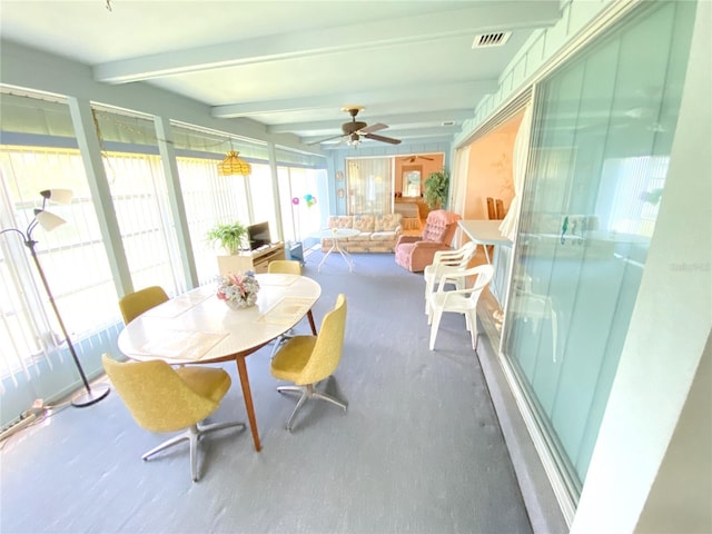 sunroom featuring ceiling fan and beamed ceiling