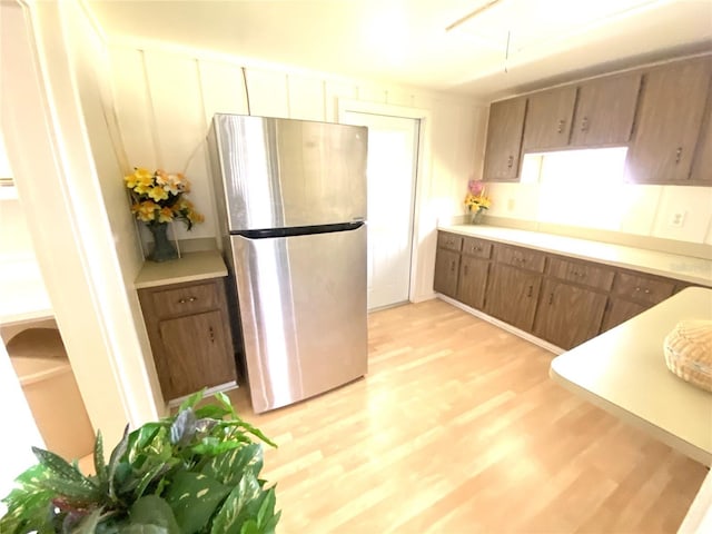 kitchen featuring stainless steel refrigerator and light hardwood / wood-style floors