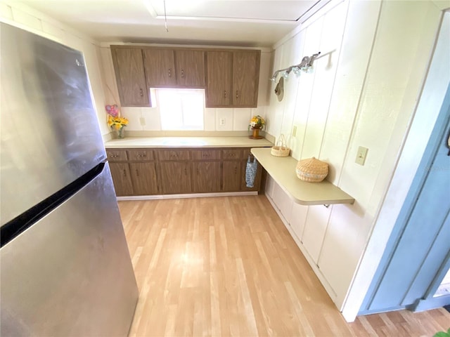 kitchen featuring stainless steel refrigerator and light wood-type flooring