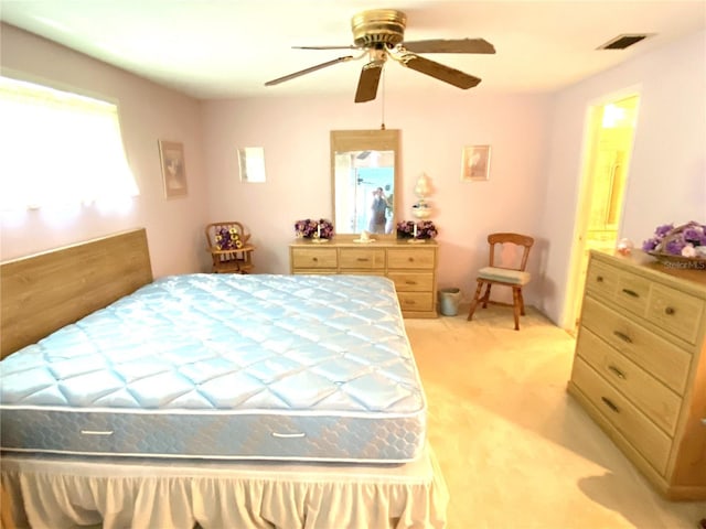 bedroom featuring light carpet and ceiling fan