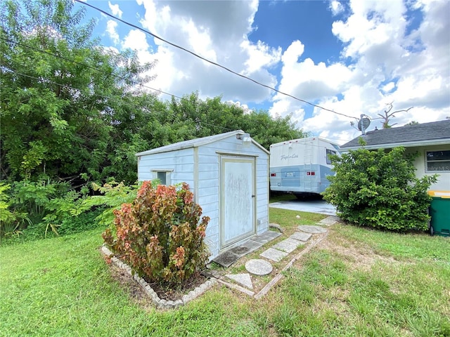 view of outbuilding featuring a yard