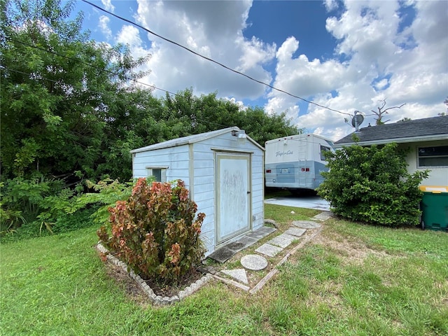 view of outdoor structure with a lawn