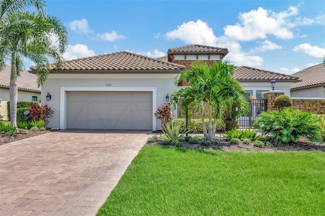 mediterranean / spanish-style house with a front yard and a garage