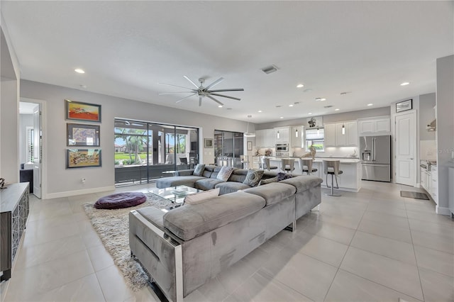 living room with ceiling fan and light tile patterned floors