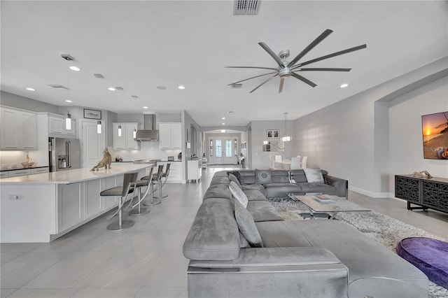 tiled living room with ceiling fan