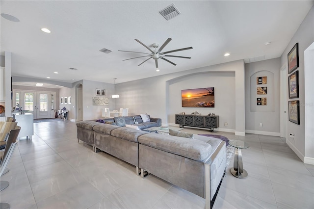 living room featuring french doors and ceiling fan