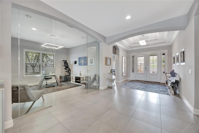 tiled foyer entrance featuring french doors and crown molding