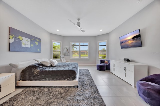 tiled bedroom featuring ceiling fan