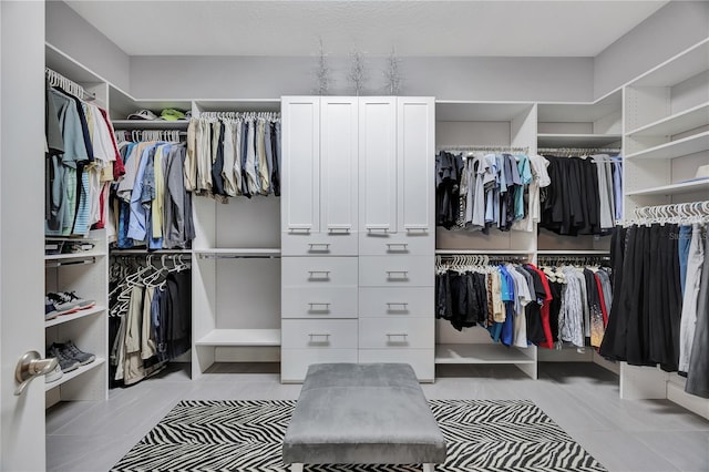 spacious closet featuring light tile patterned flooring