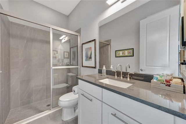 bathroom featuring toilet, walk in shower, vanity, and tile patterned flooring