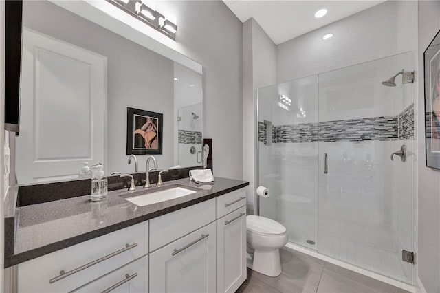 bathroom featuring vanity, toilet, tile patterned floors, and an enclosed shower