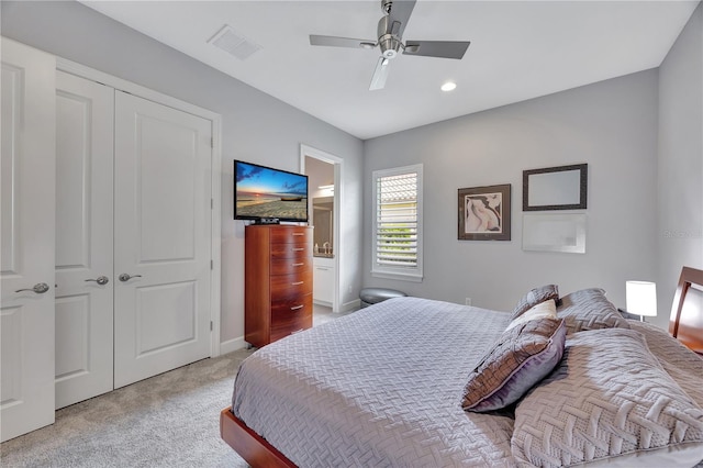 carpeted bedroom featuring a closet and ceiling fan