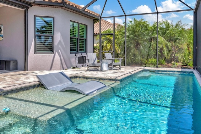 view of pool featuring a patio area and glass enclosure