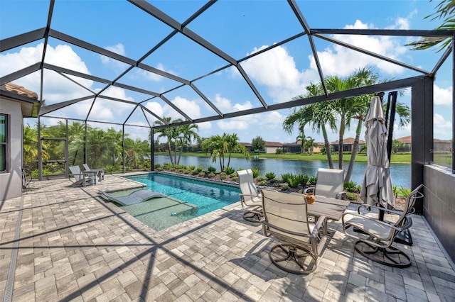 view of swimming pool featuring a patio, a water view, and a lanai